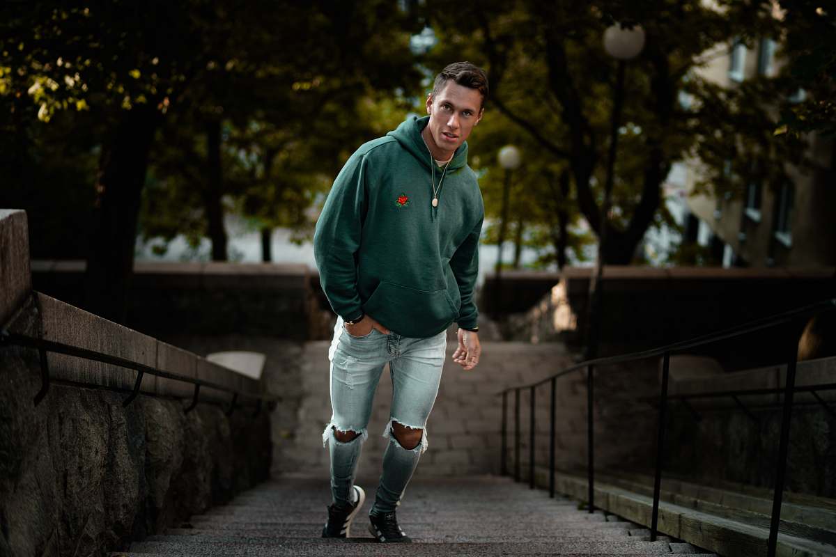 people man in green hoodie on stair person