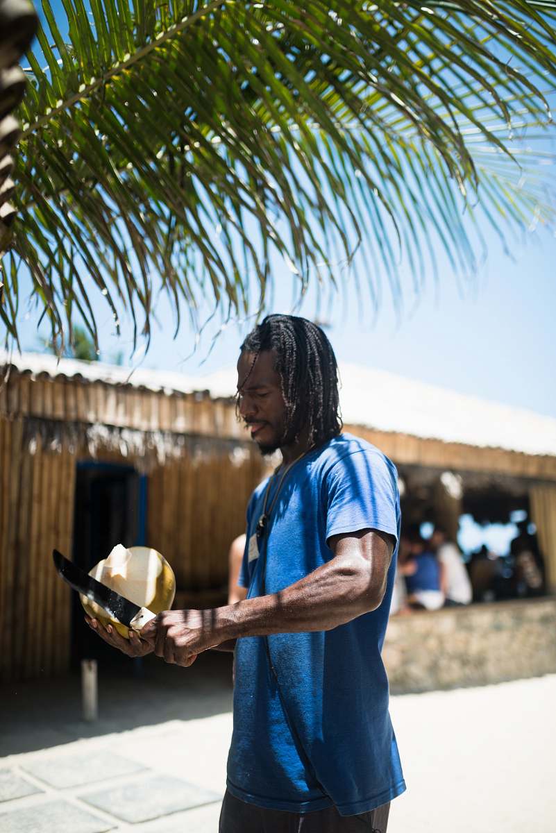 people man peeling coconut person