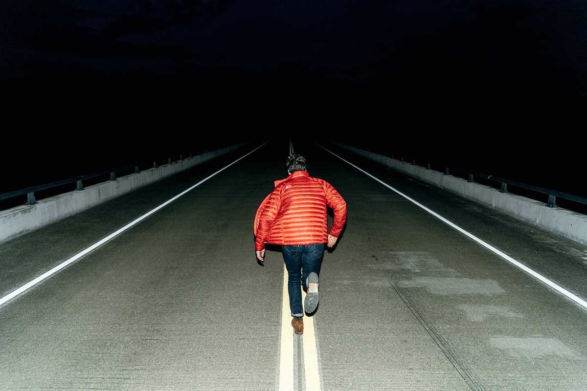 people man running on road during night time person