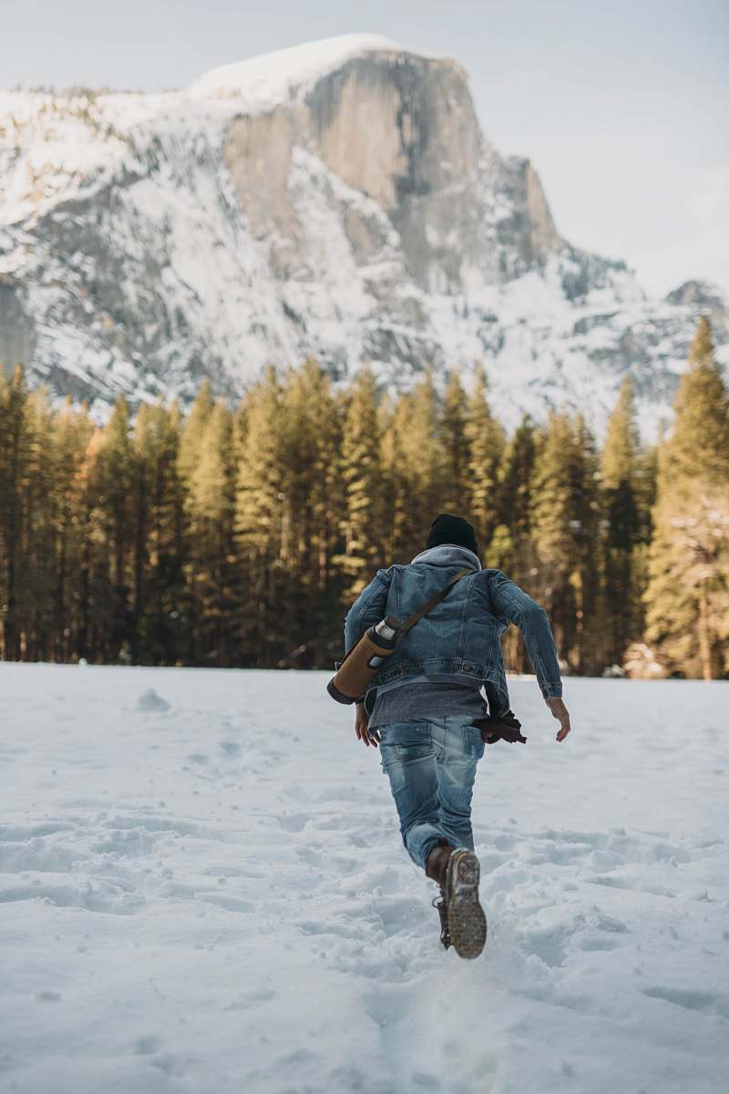 people man running on snow near snowy mountain during daytime person