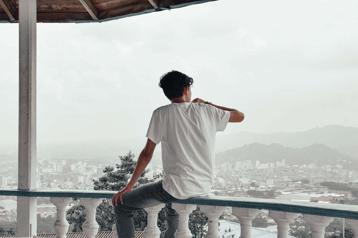people man sitting on balcon person