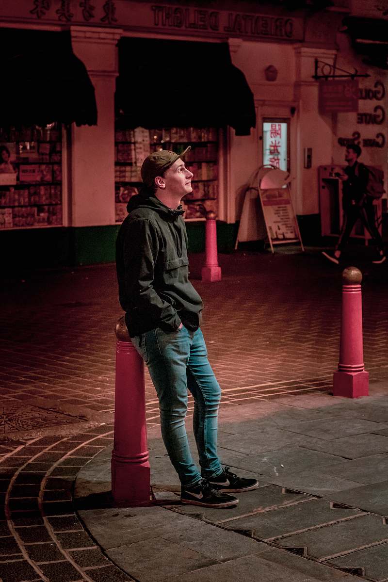 people man standing at road during night time person