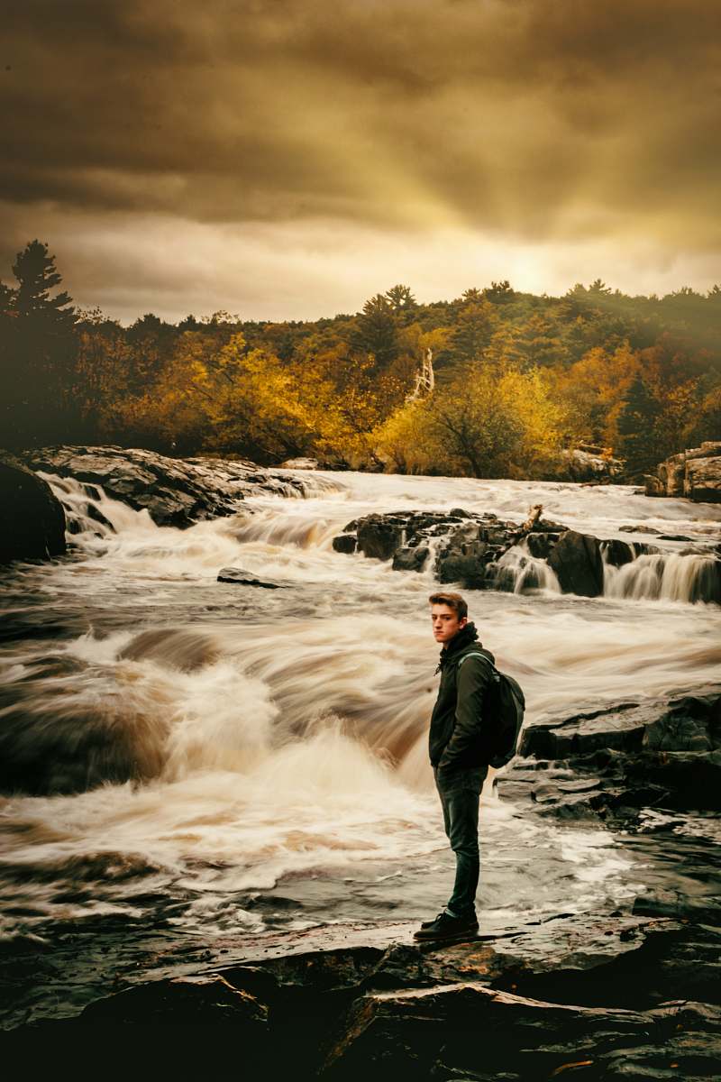 people man standing beside river person