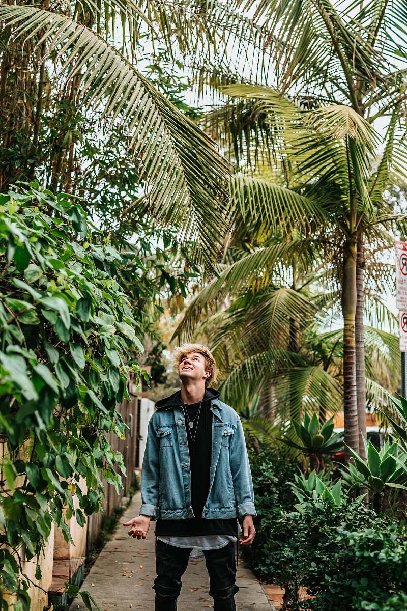 people man standing between green leafed plant person