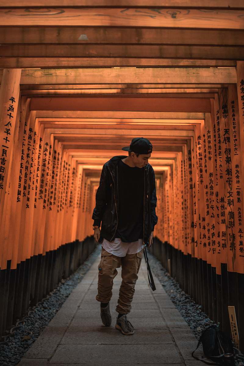 people man standing between torii gate person