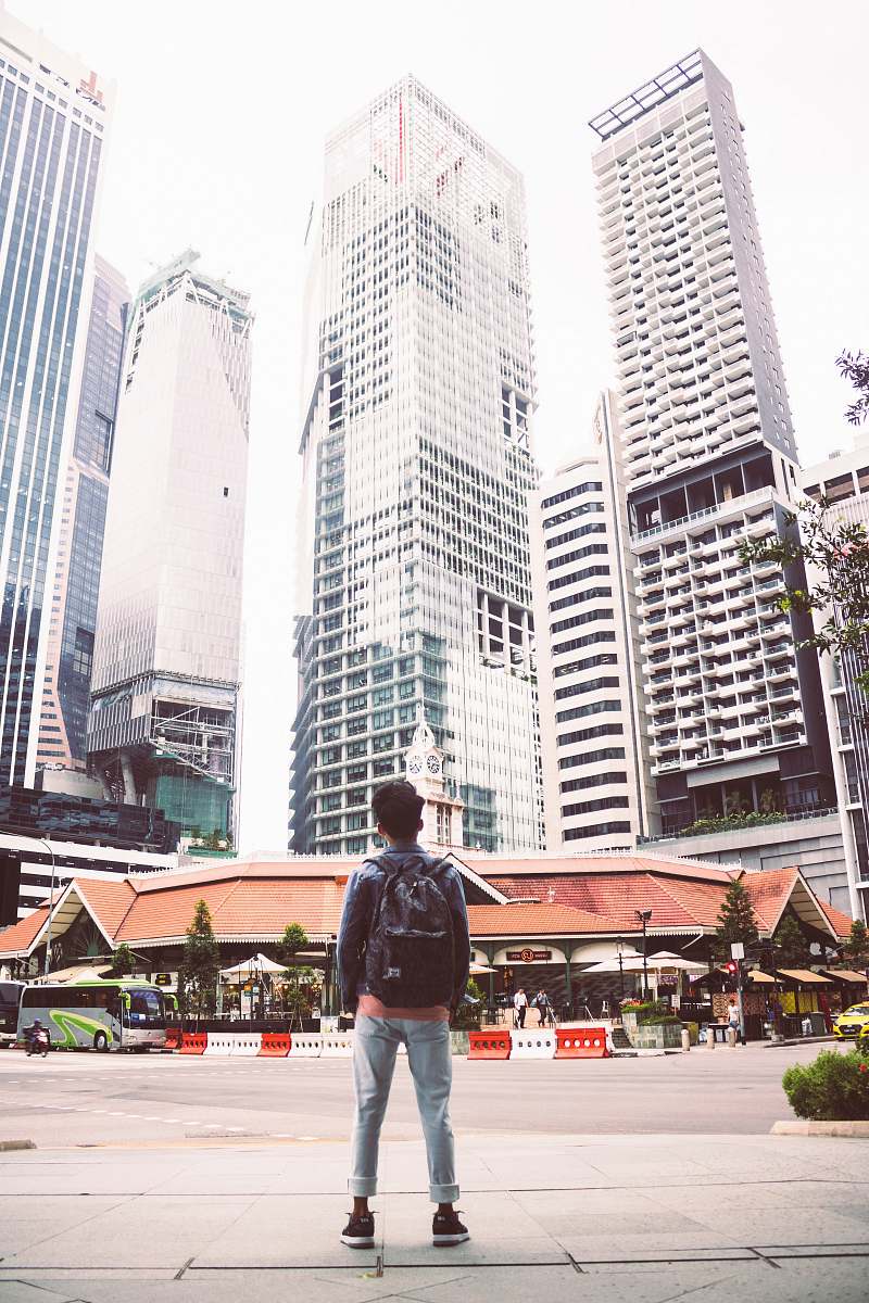 person man standing in front of building people