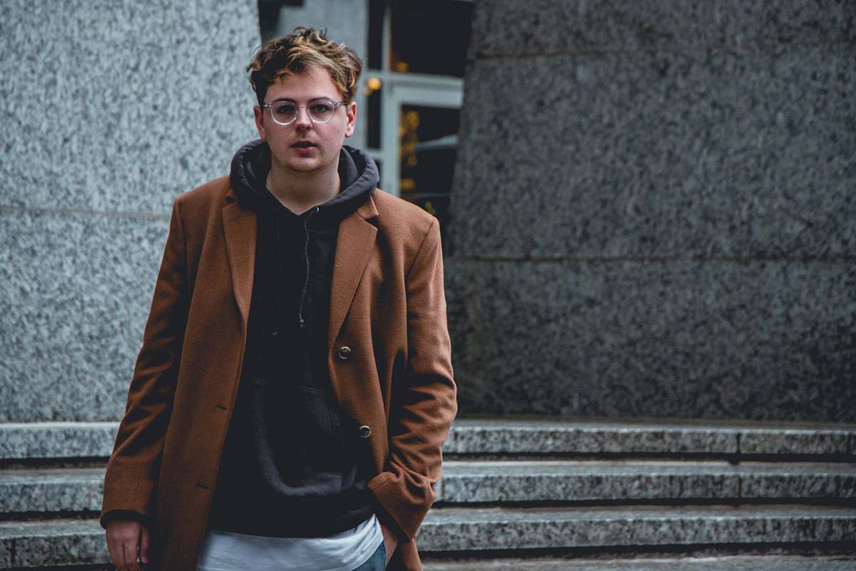 people man standing in front of gray concrete building person