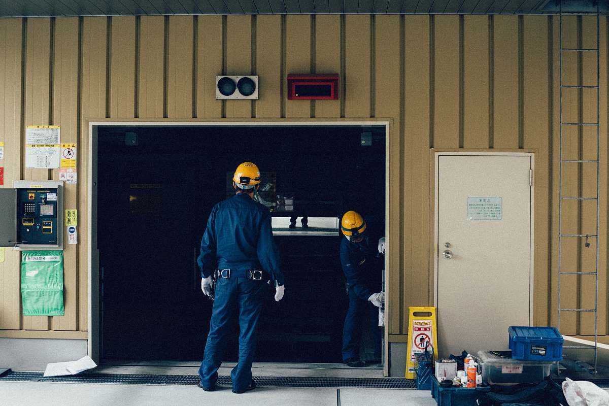 people man standing in front of open doorway person