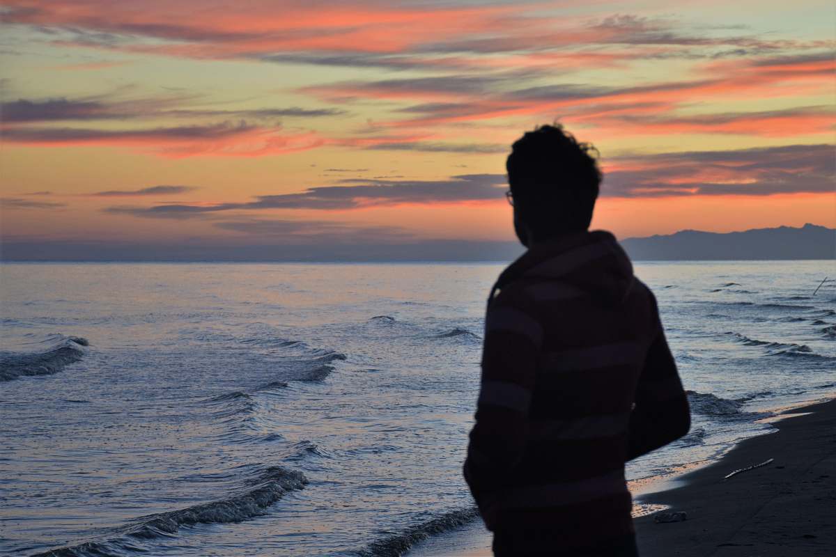 people man standing in front of seashore sea