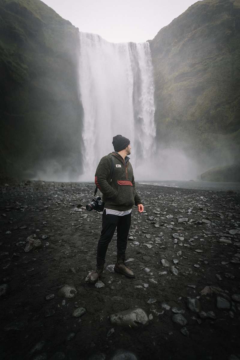 people man standing in front of waterfall person