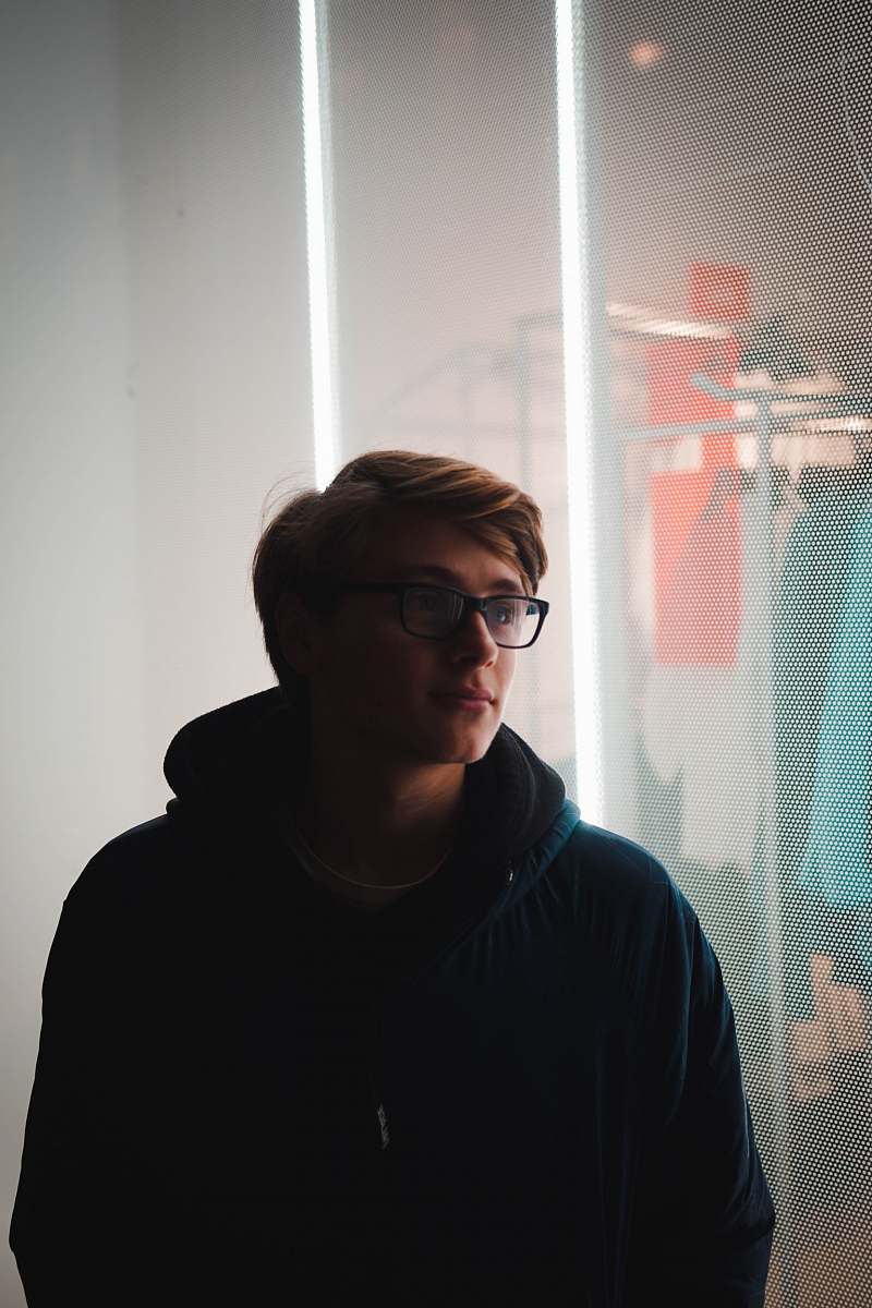 people man standing near glass window person