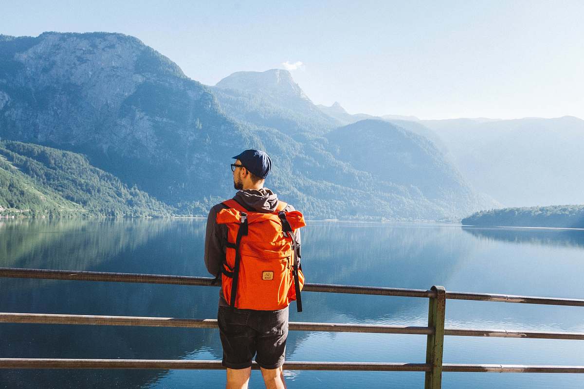 person man standing near grey railings people