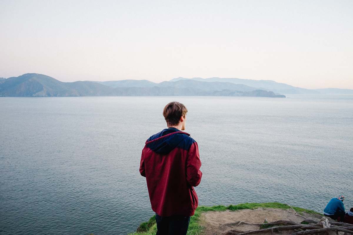 people man standing on cliff person