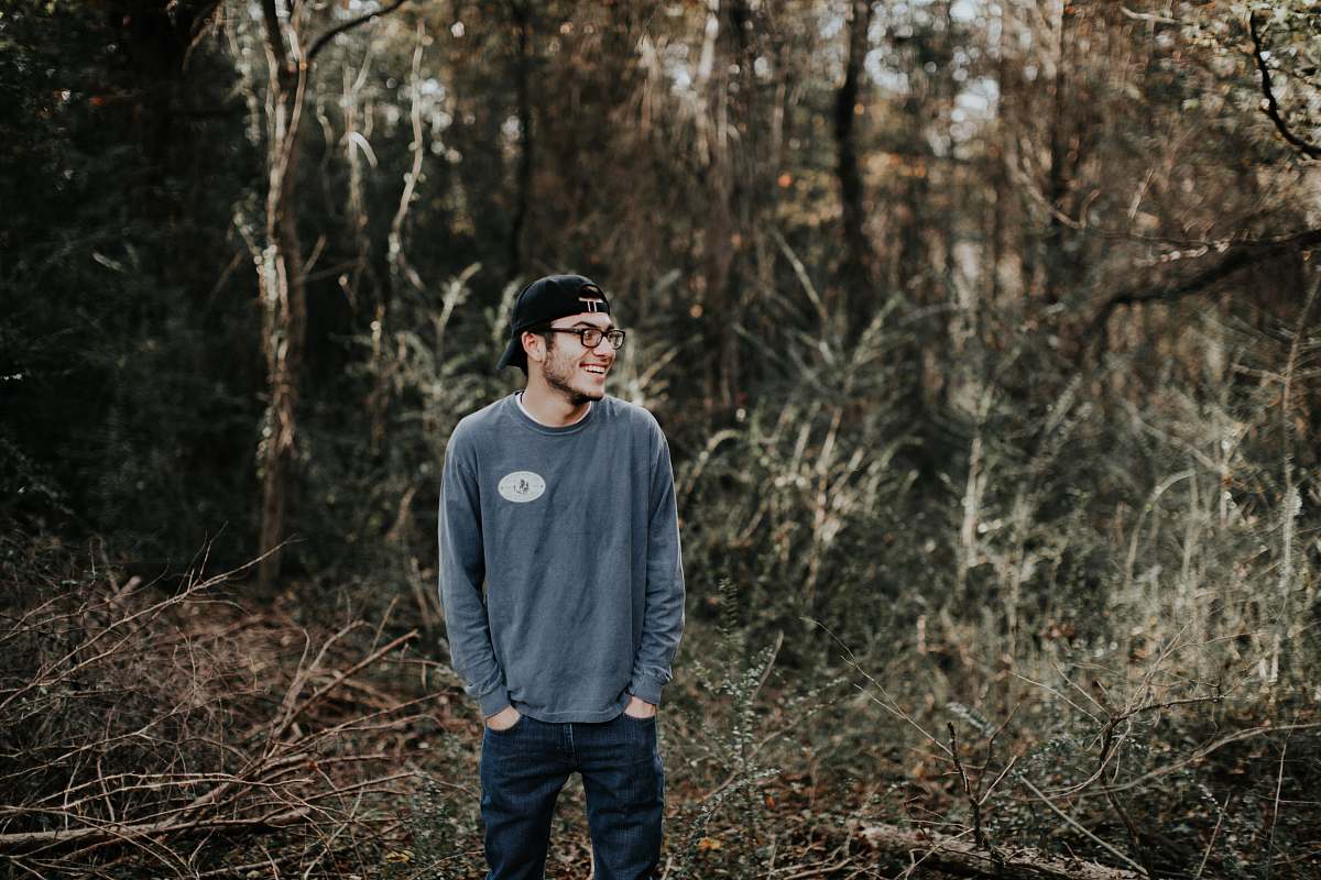 person man standing on forest during daytime people
