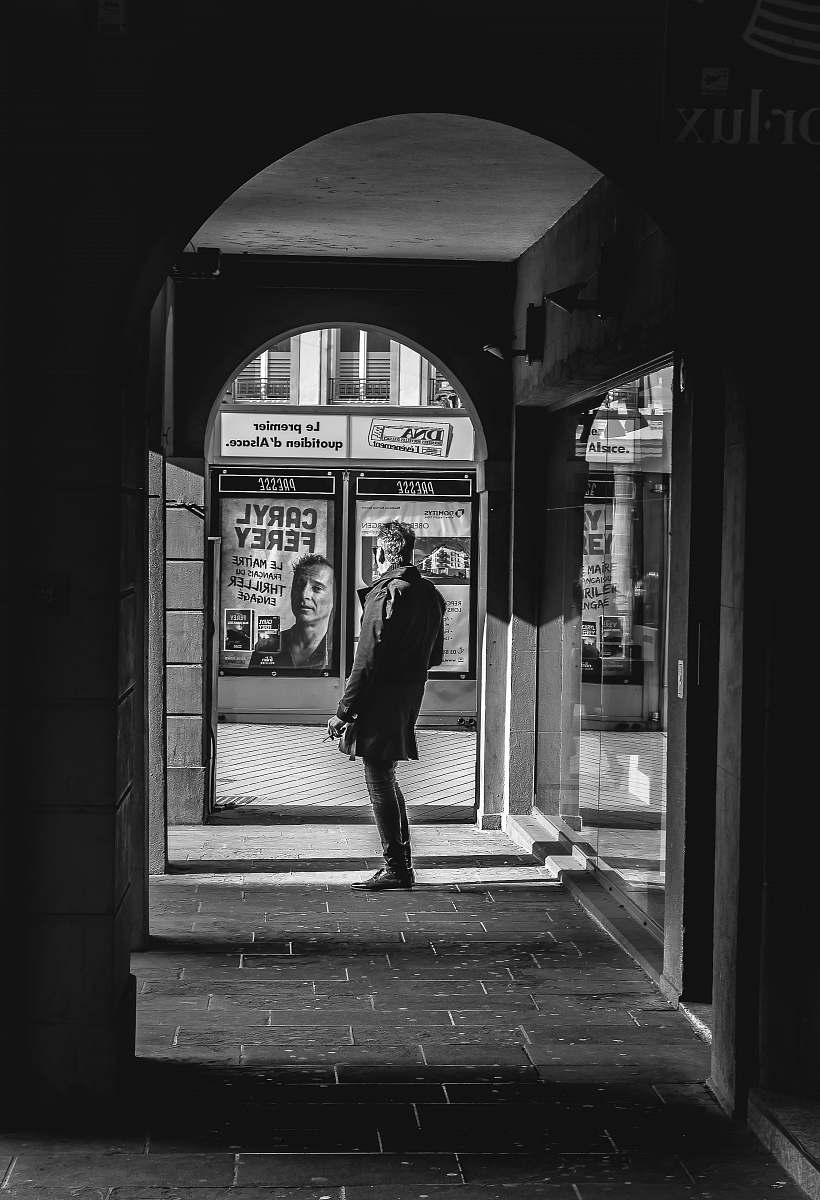 person man standing on hallway black-and-white