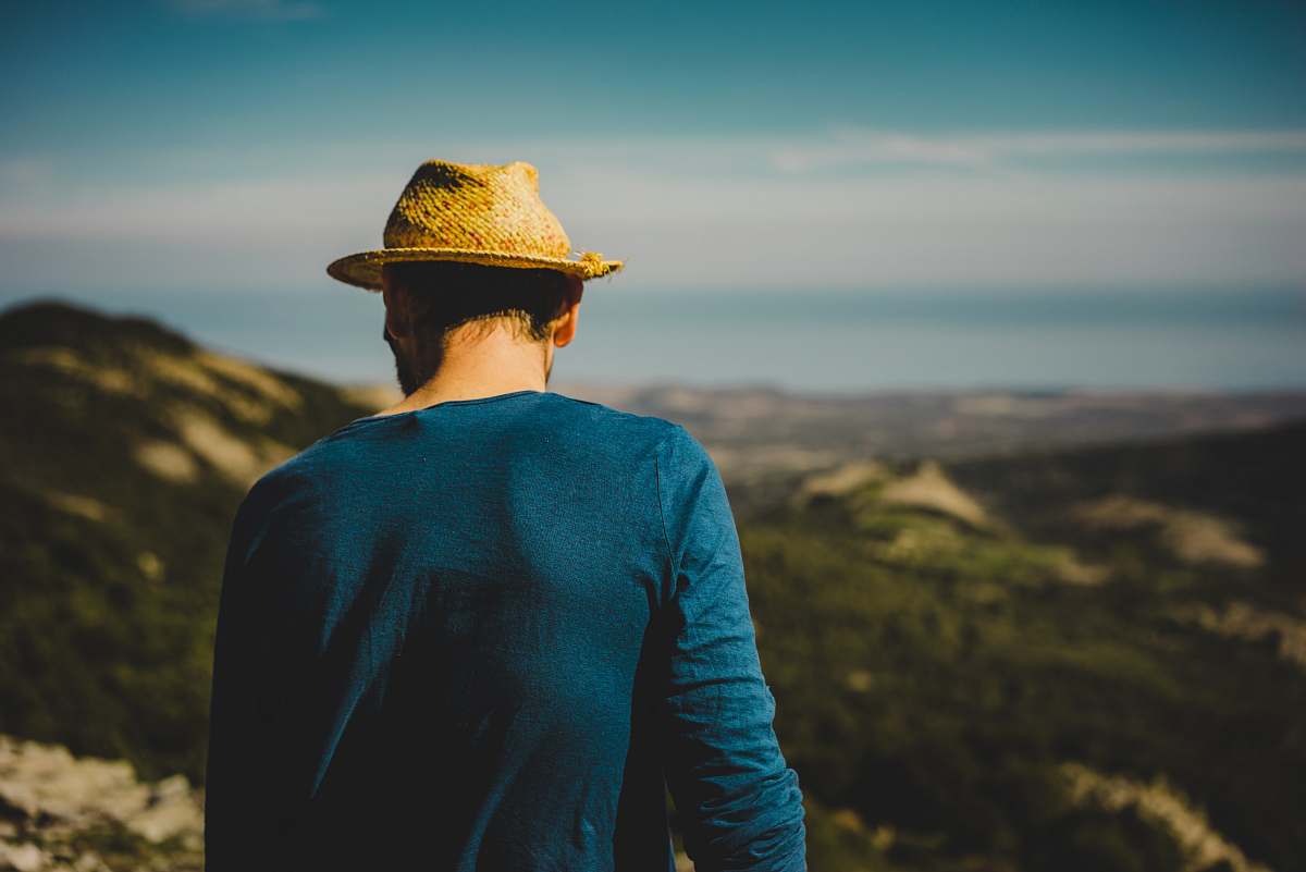 people man standing on hill hat