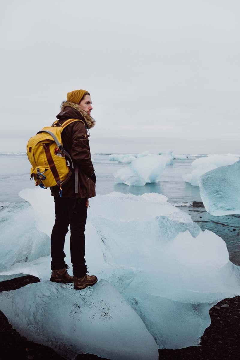 person man standing on ice rack under gray sky people