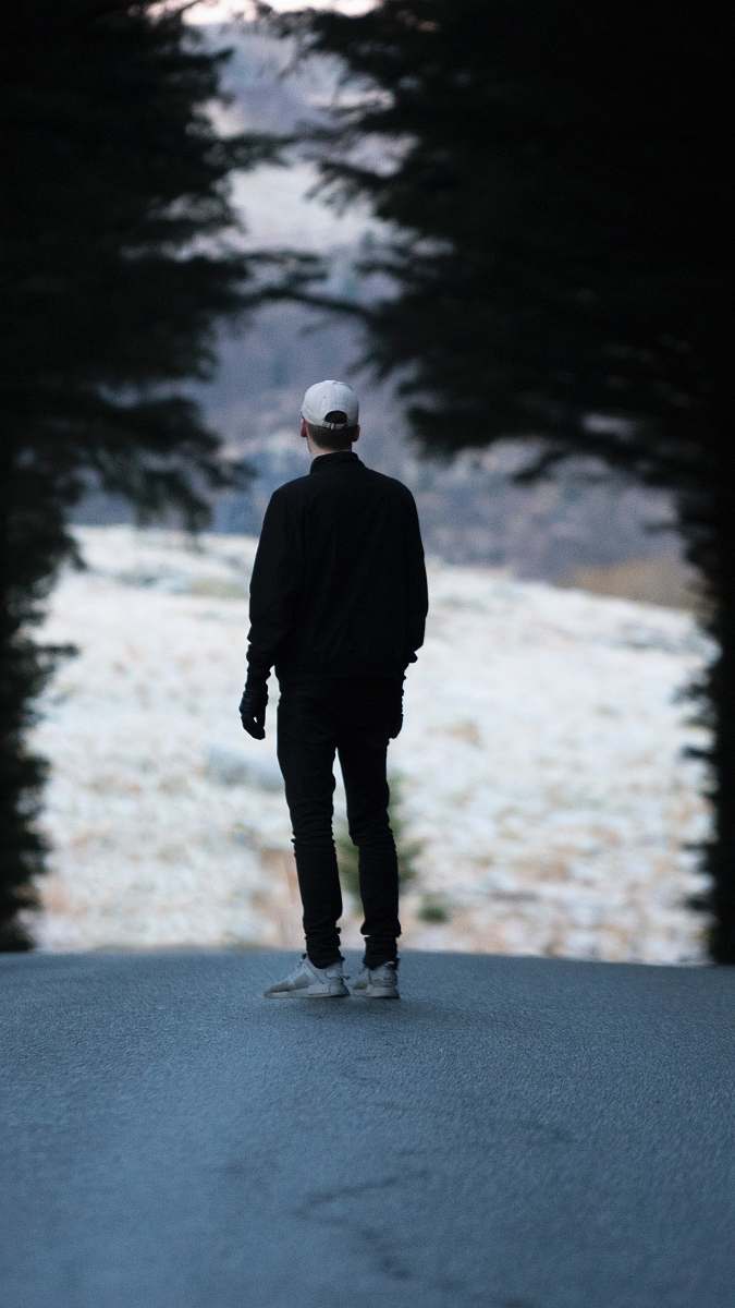 people man standing on pathway with trees person
