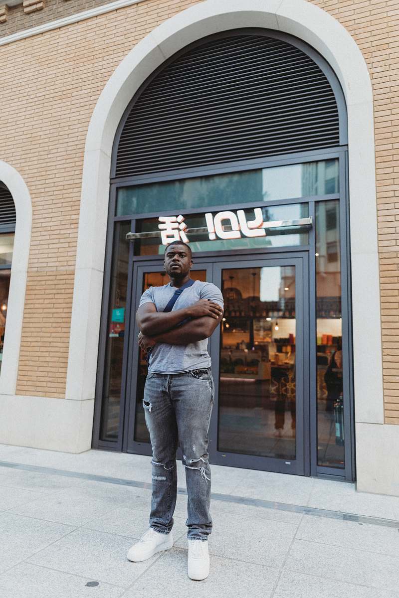 people man standing on Yo! store front person