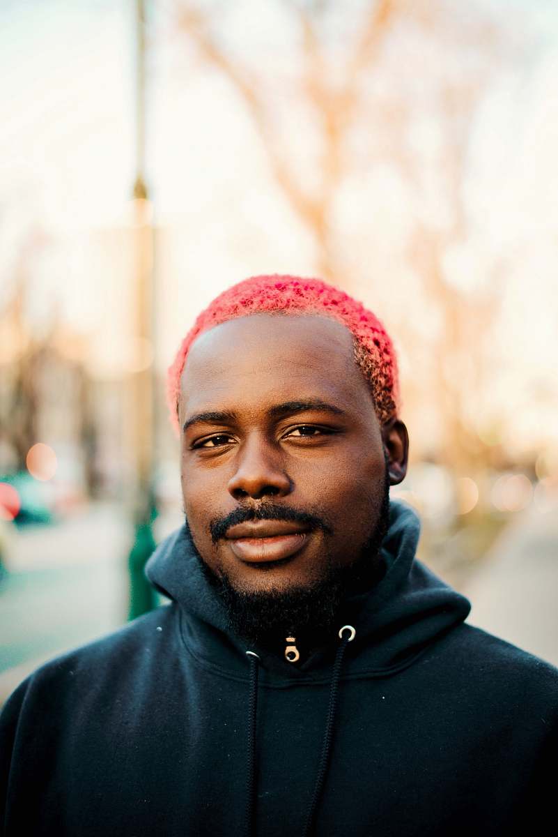person man standing while looking sideway people