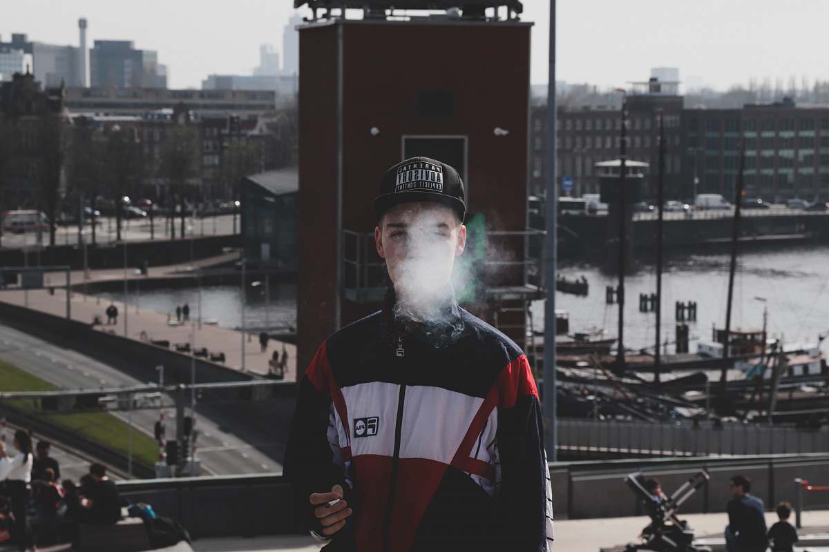 people man standing while smoking person
