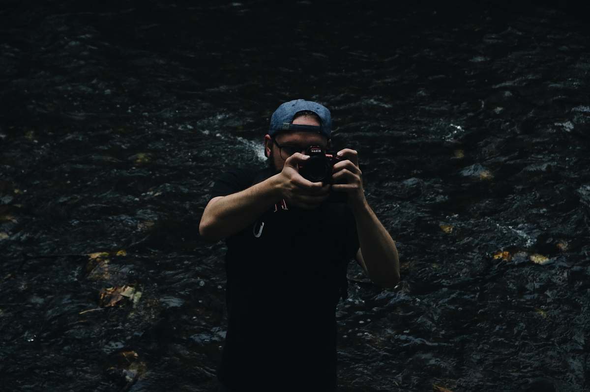 people man taking a photo using a DSLR camera person