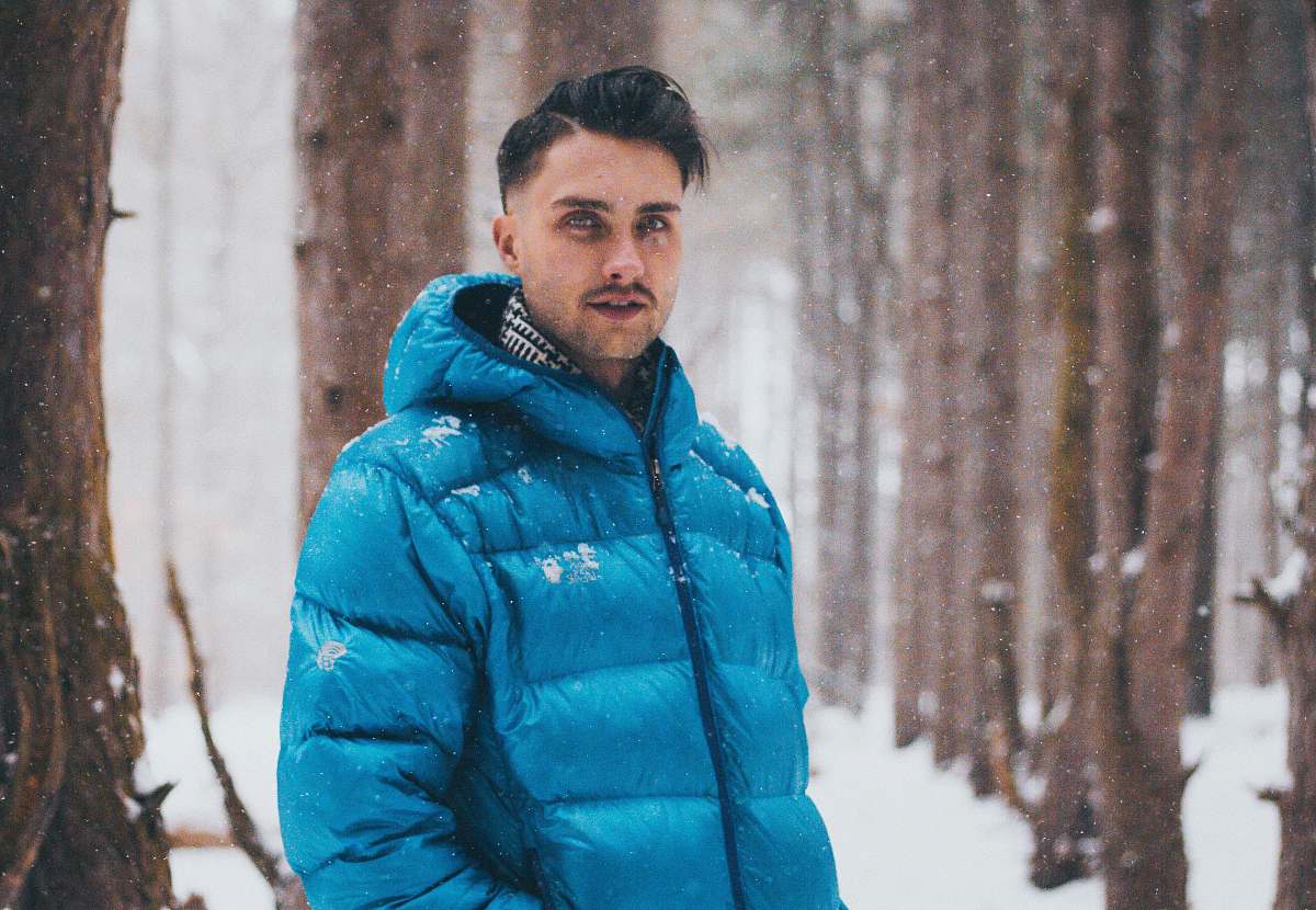 people man taking picture on snow sand beside trees person