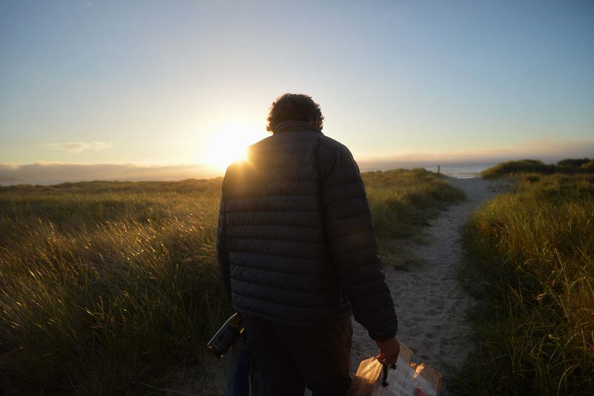 person man walking across the road during sunrise people