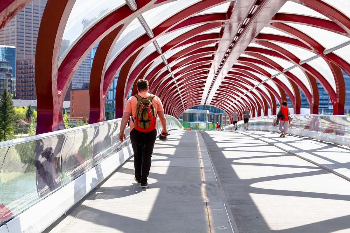 people man walking on arch bridge person