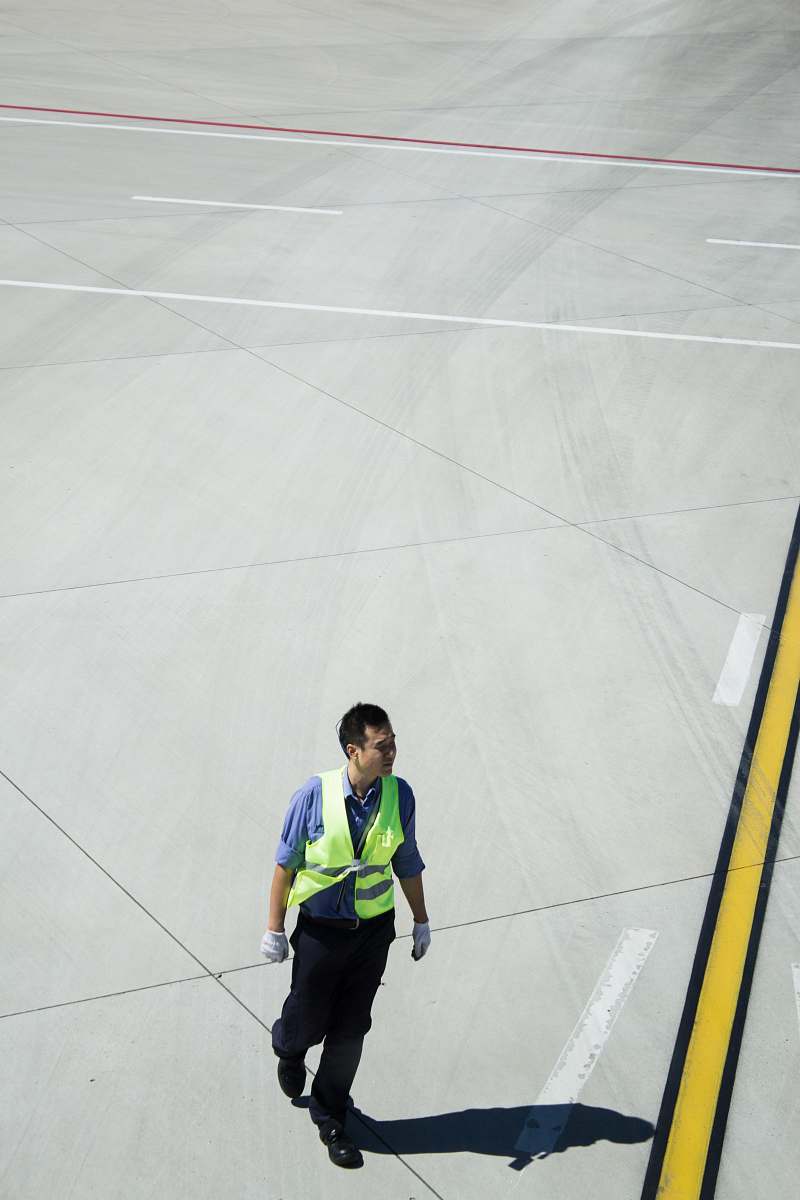 person man walking on concrete pavement people