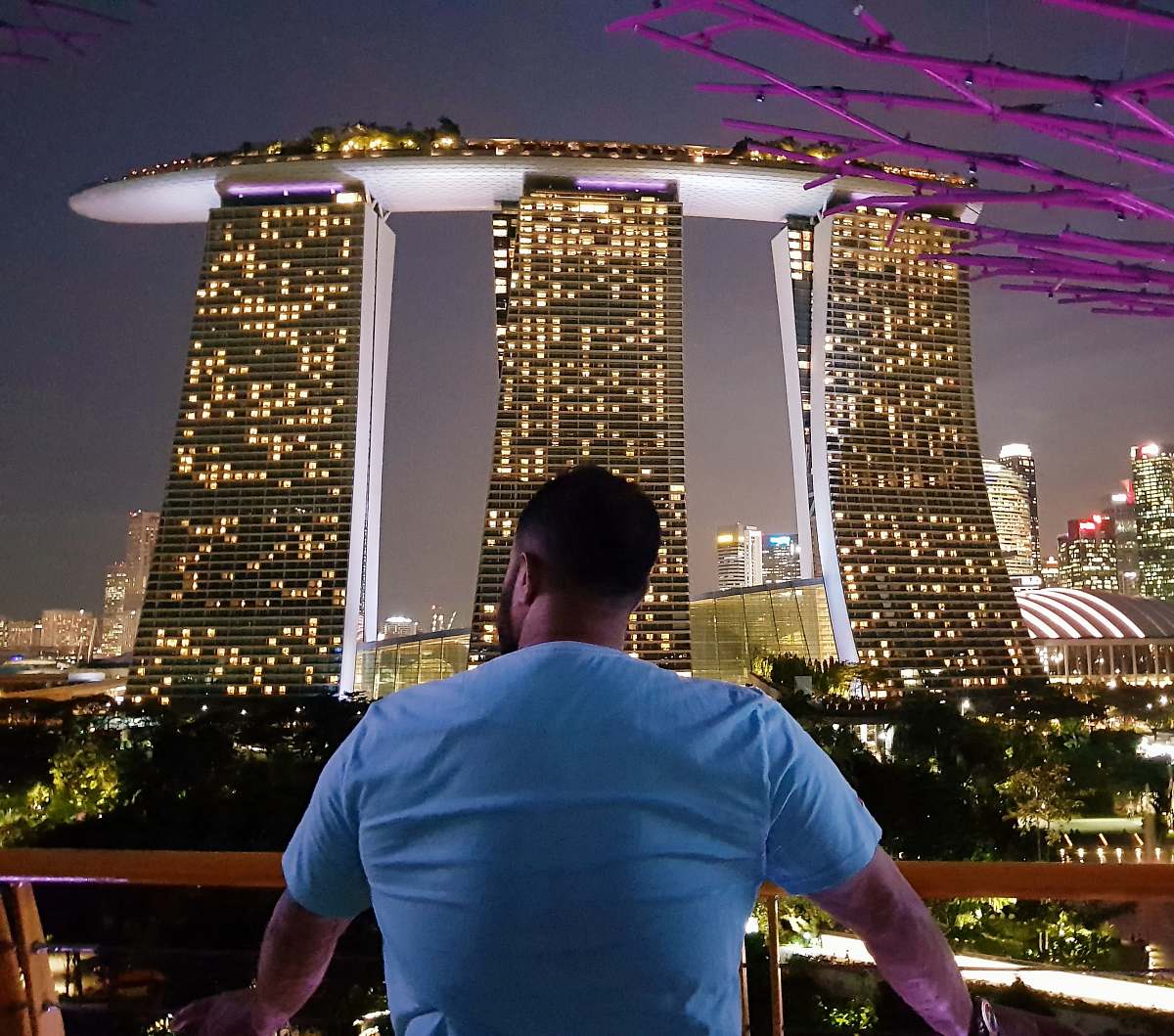 people man watching high-rise buildings at nighttime person