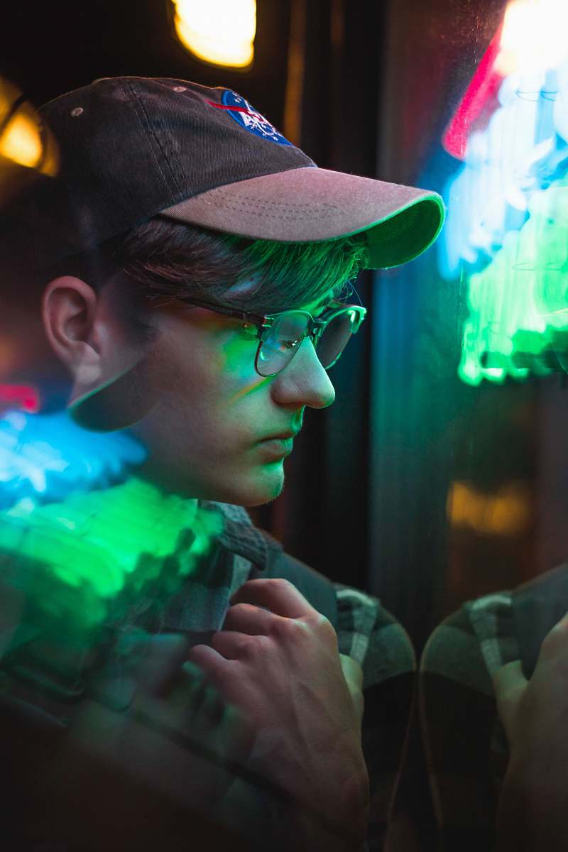 person man wearing black framed eyeglasses near green lights people