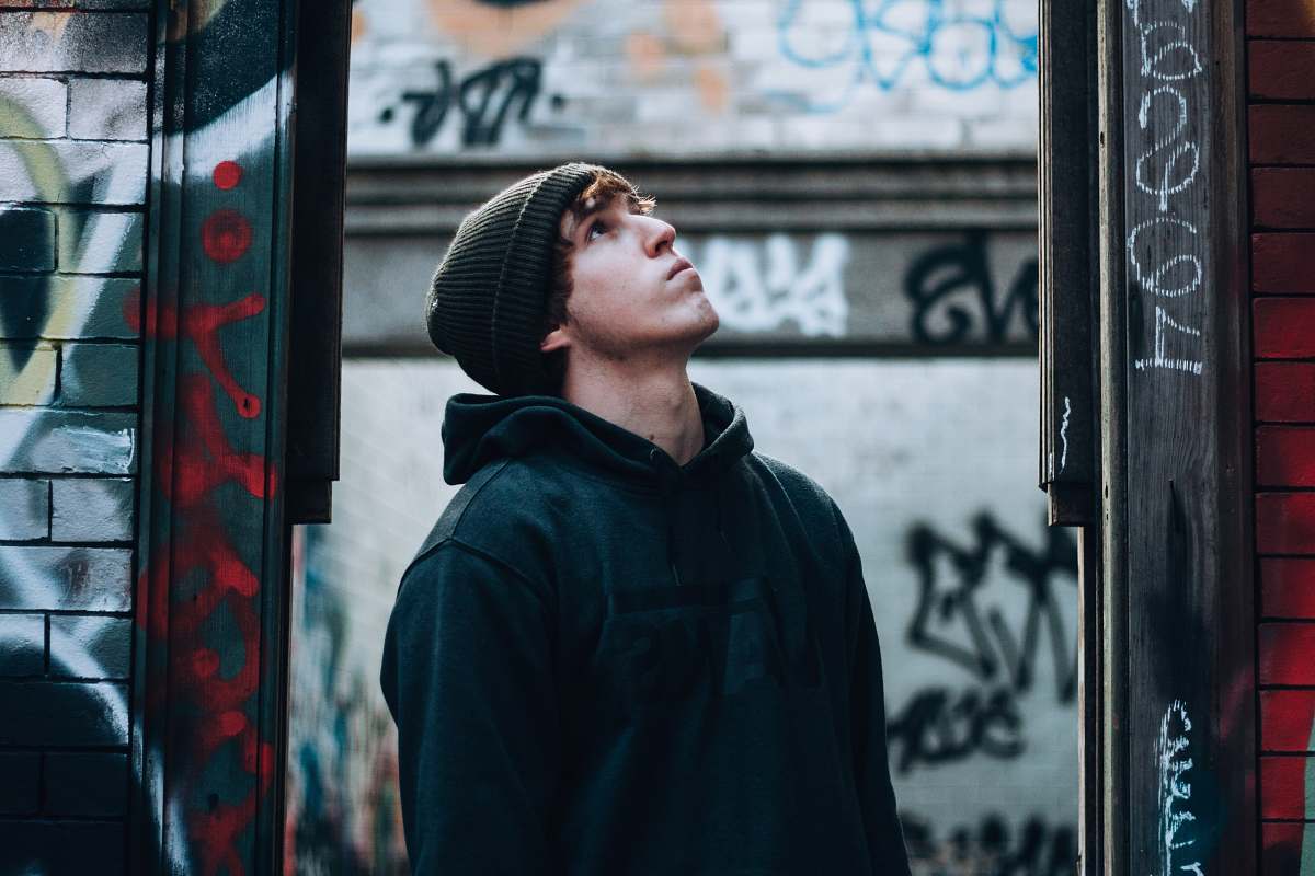 people man wearing black hoodie looking up person