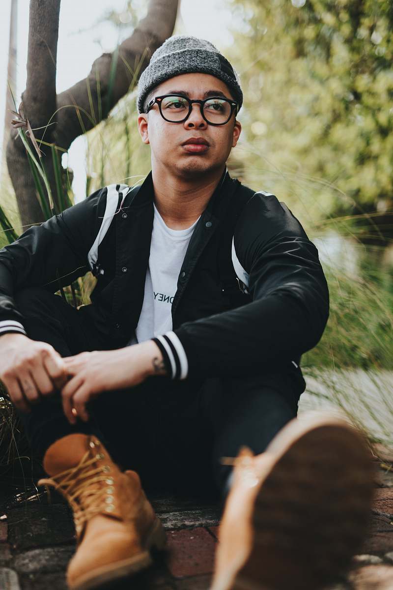 people man wearing black jacket sitting near tree person