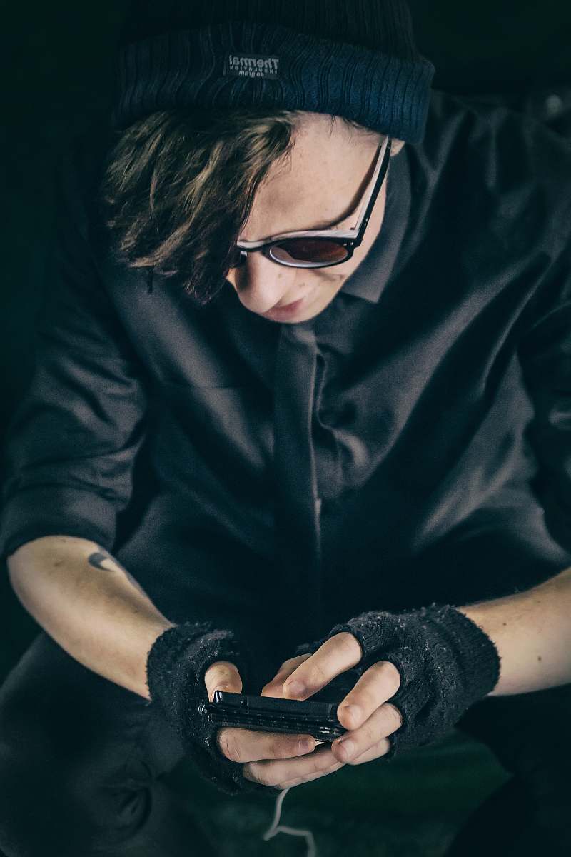 people man wearing black top using smartphone person