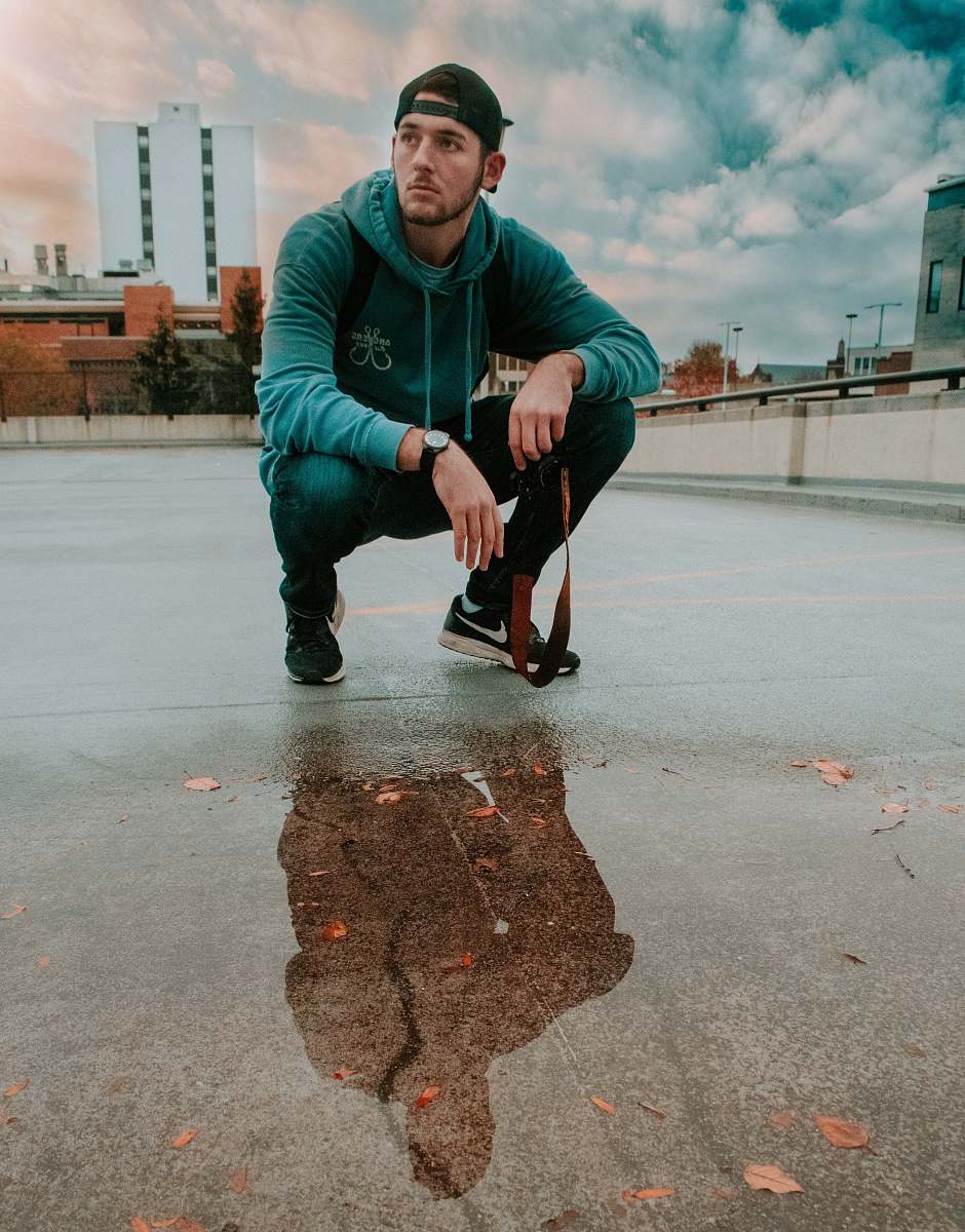 people man wearing blue hoodie docking on rooftop of the building person