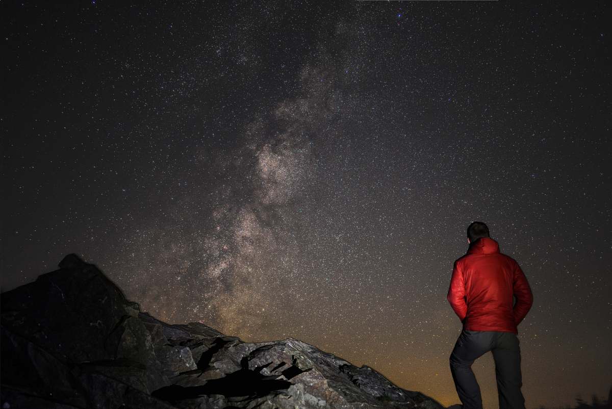 people man wearing red jacket watching the milkyway person
