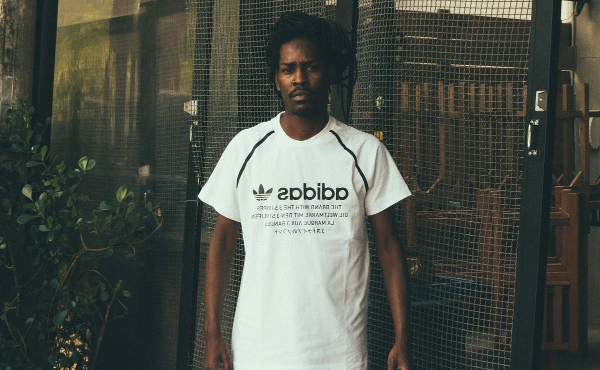 people man wearing white and black adidas crew-neck t-shirt person