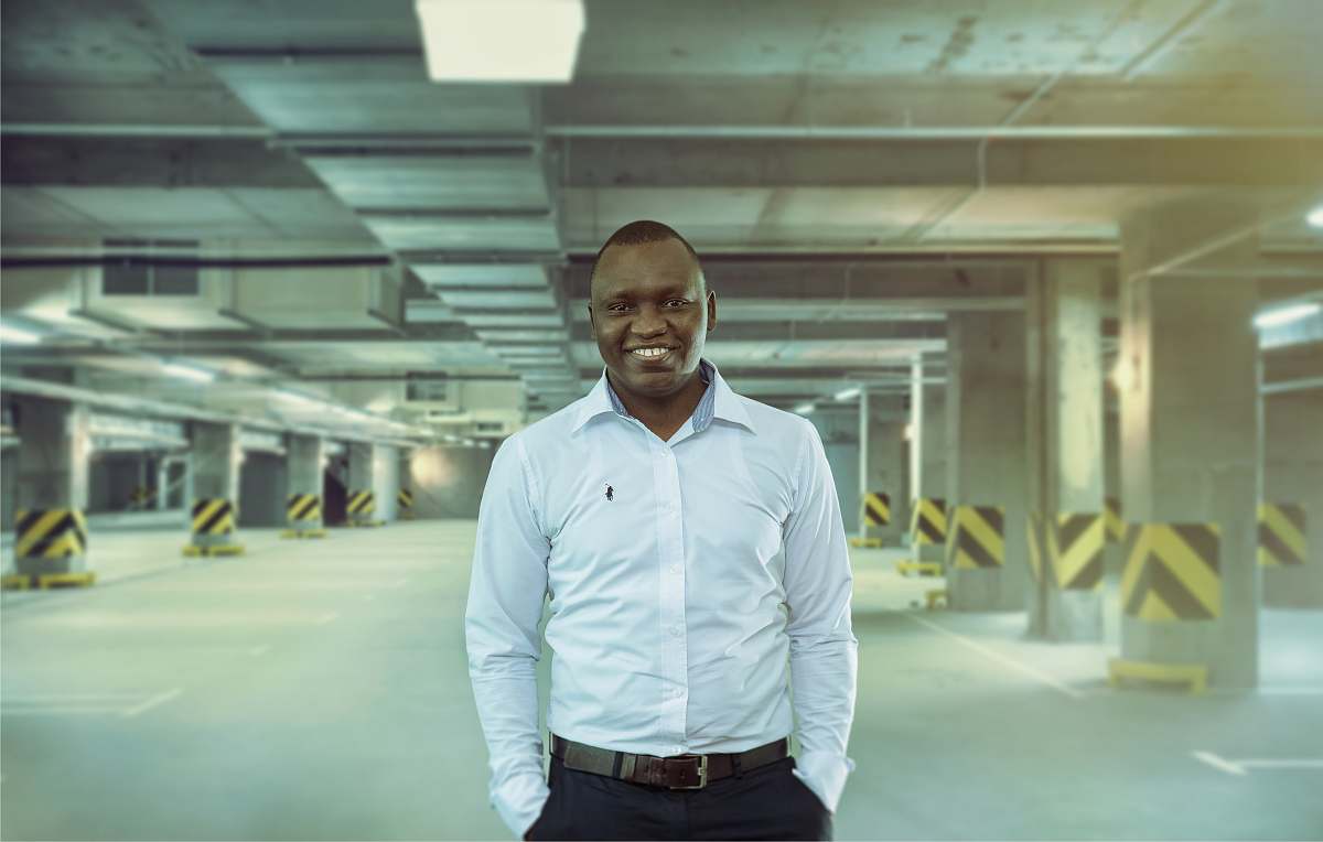 people man wearing white dress shirt standing inside parking lot person