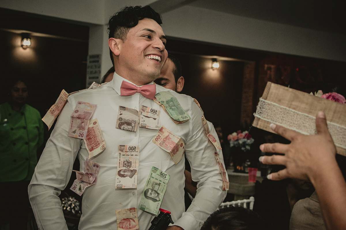 people man wearing white formal suit with banknotes hanging person