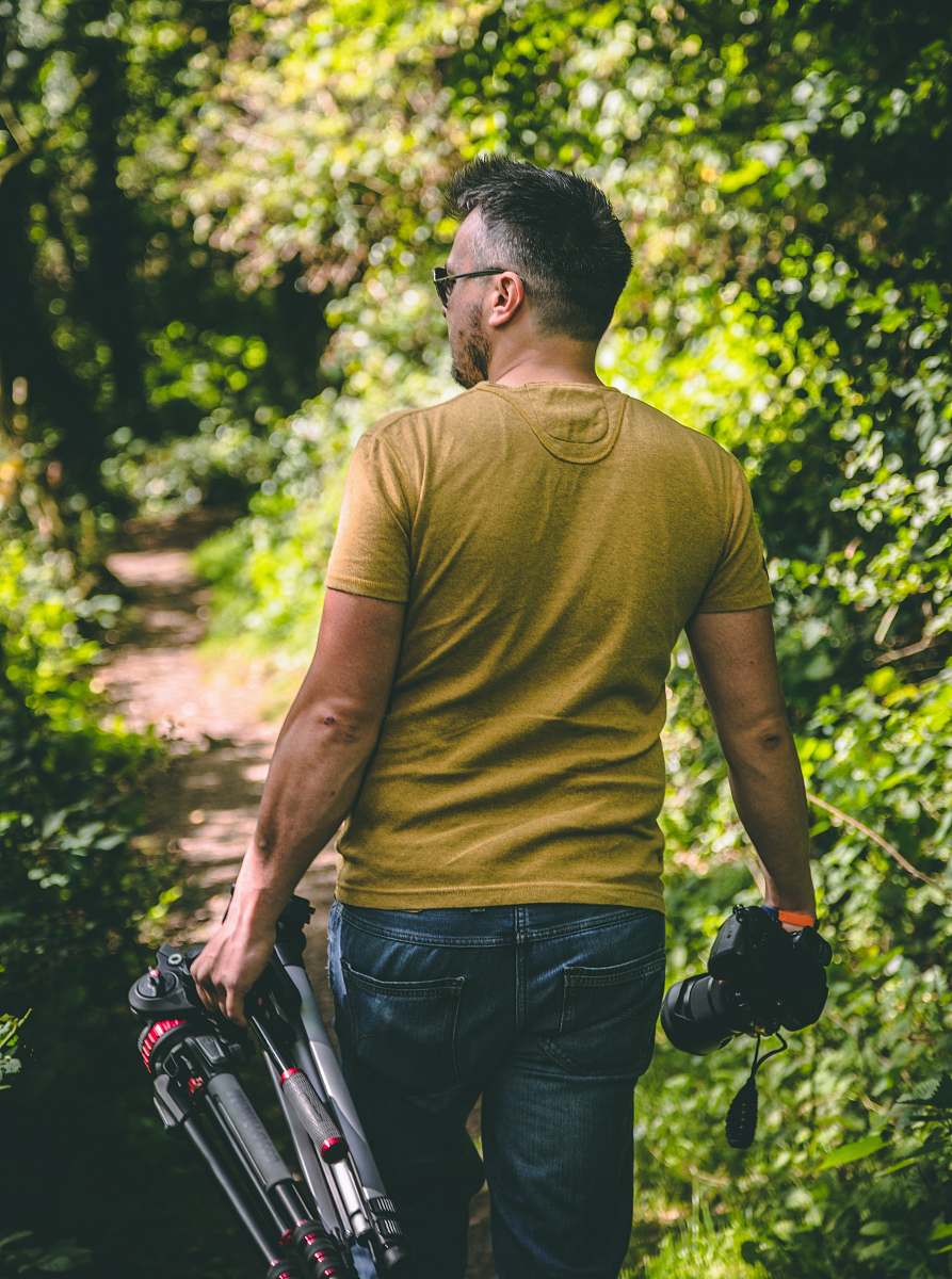 people man wearing yellow T-shirt holding tripod and DSLR camera person