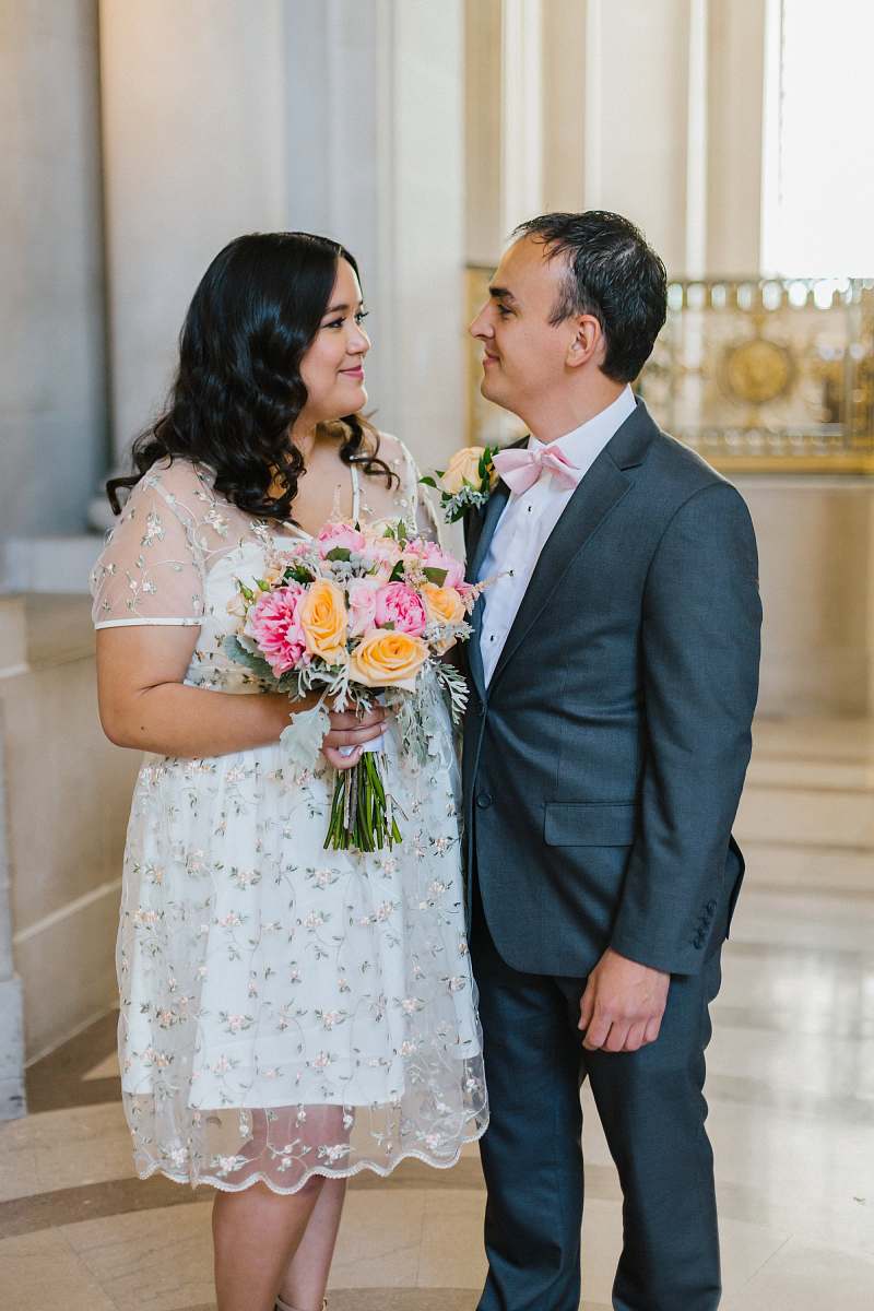 people married couple standing inside concrete building person