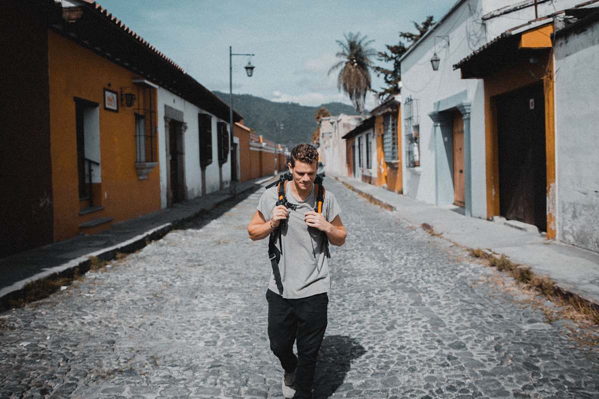 people one unknown celebrity in gray shirt walking between houses person