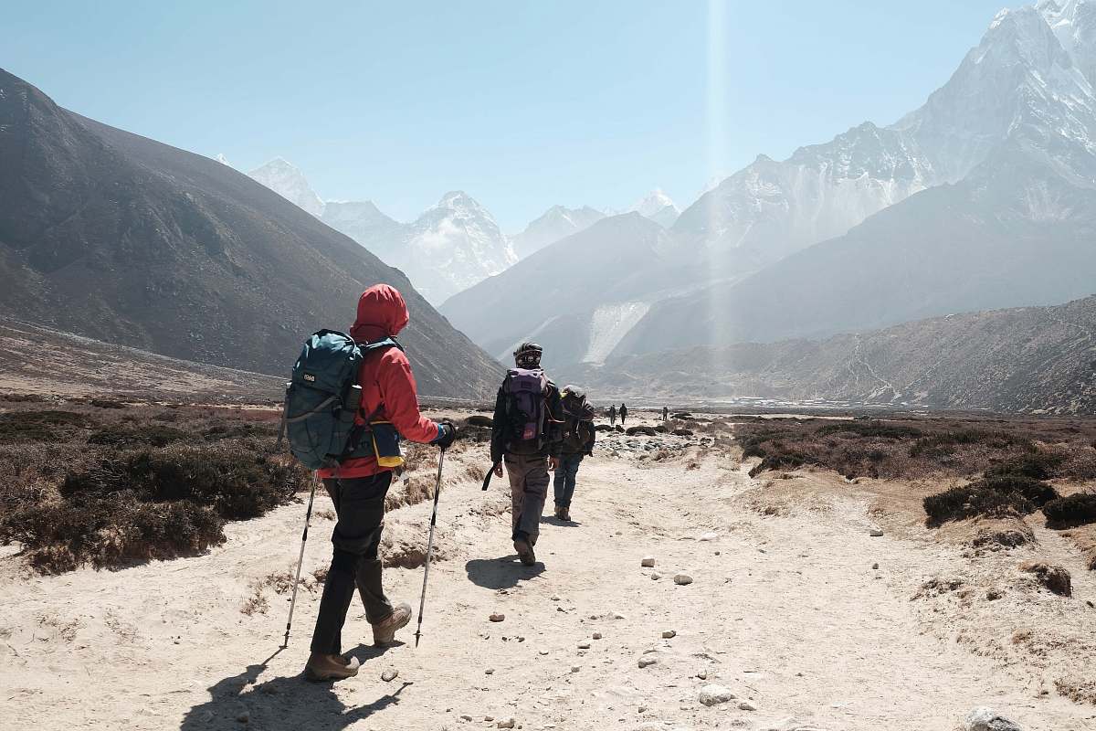 people people hiking towards mountain ranges hiking