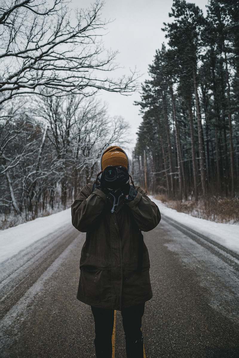 person person in brown jacket holding camera people