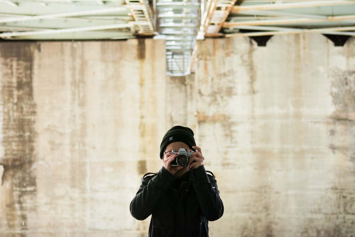 person person in jacket holding jacket during daytime photographer