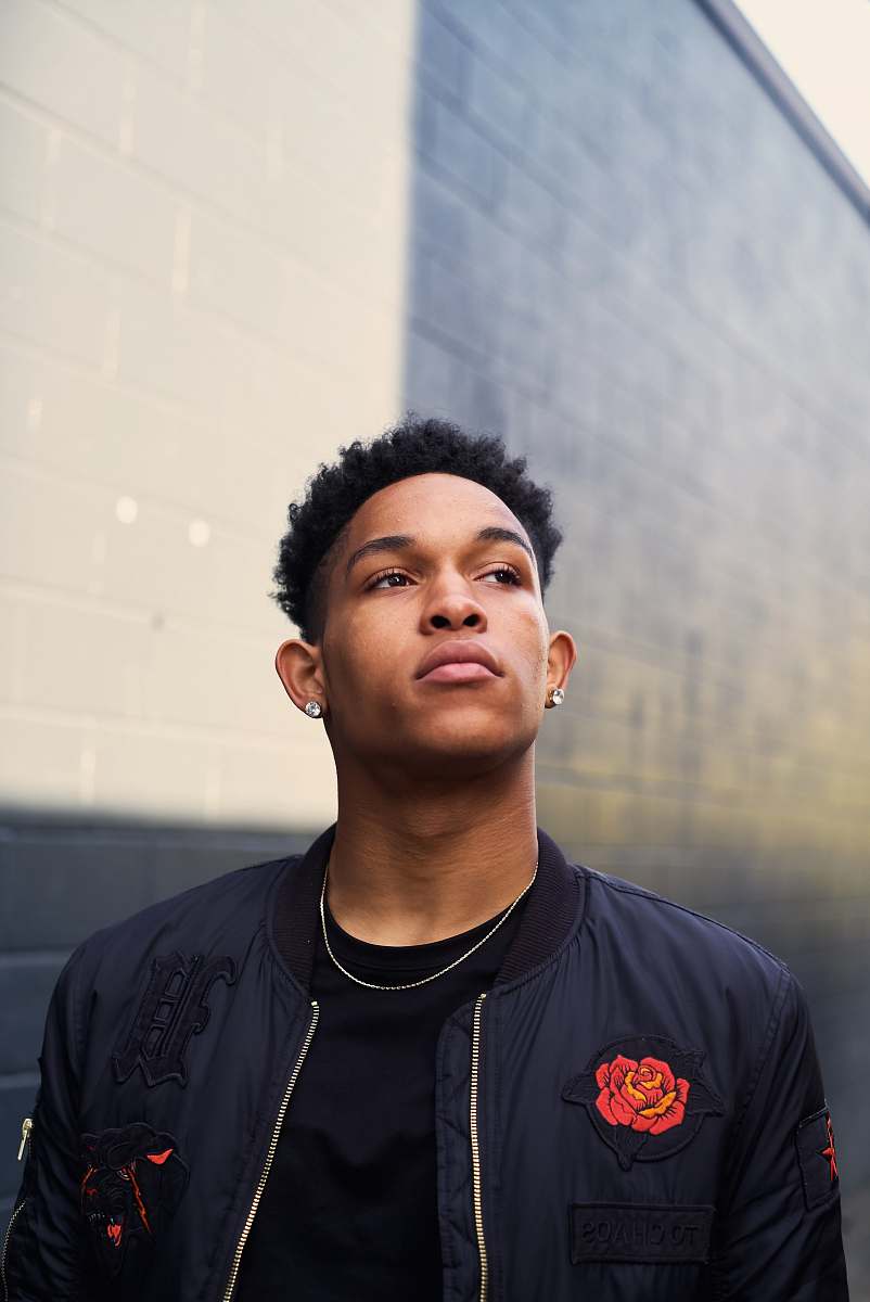 people photo of man wearing black jacket looking up person