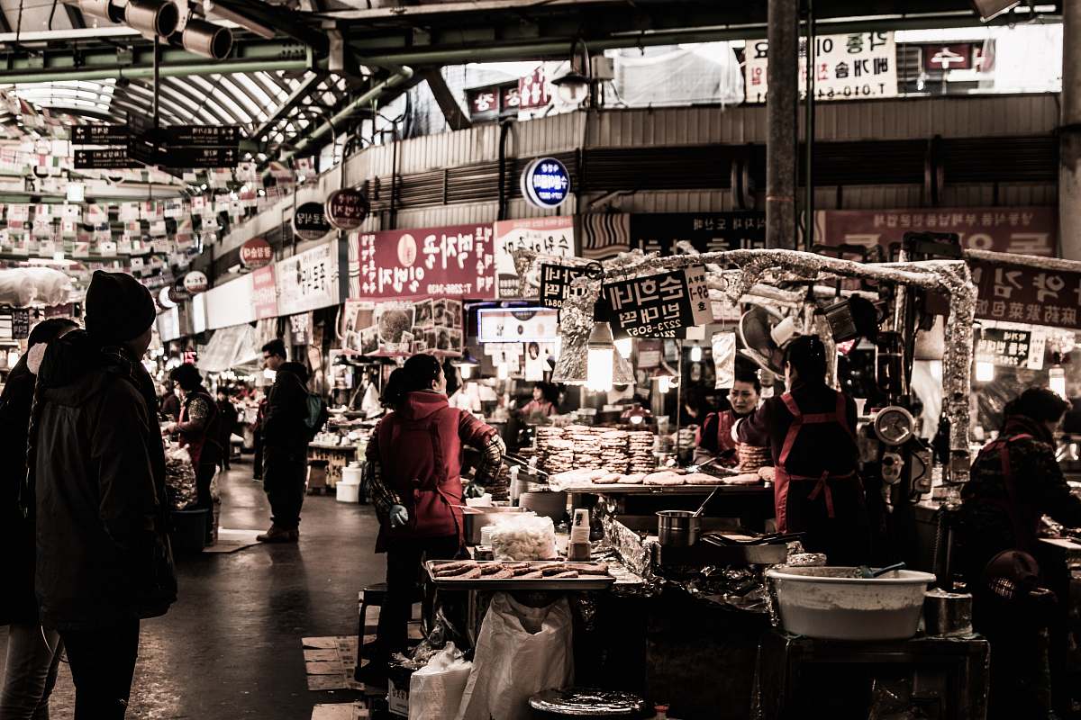 people photo people standing inside grey concrete building market