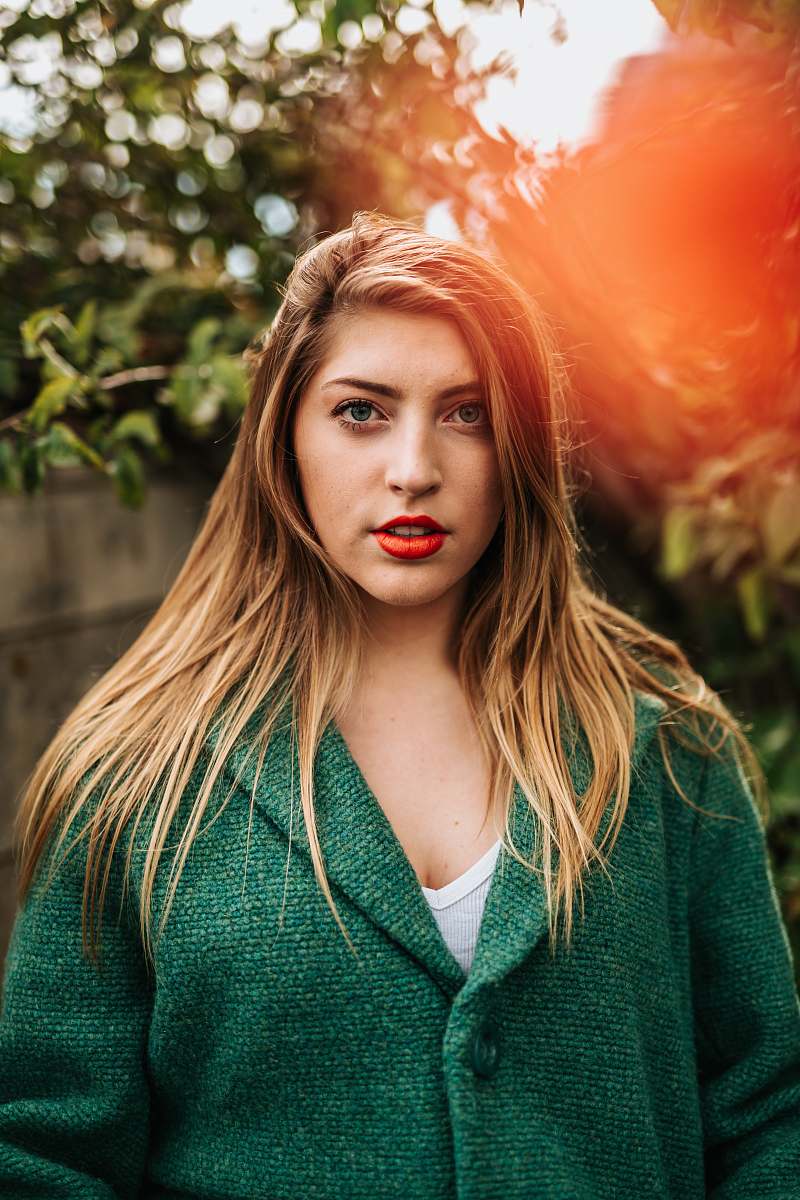 people portrait photography of woman in green coat person