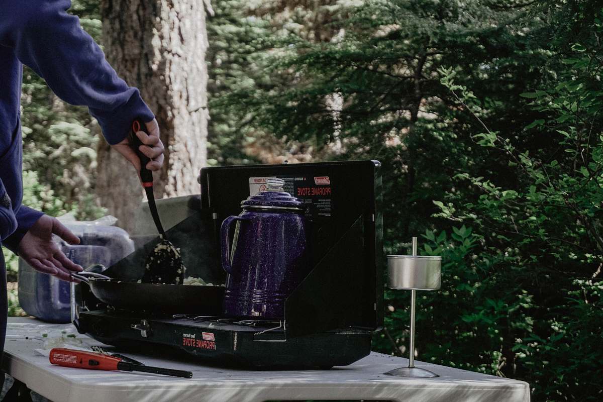 people purple electric kettle on stove person